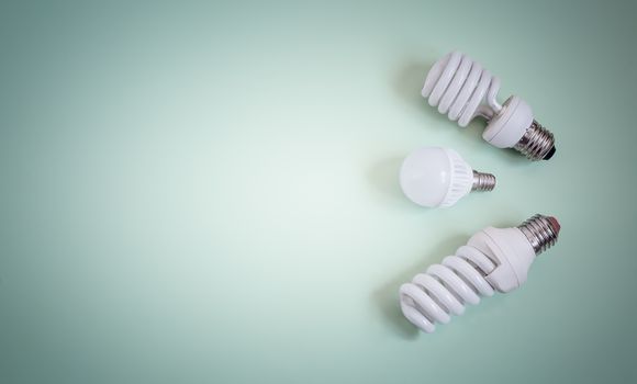 Electric energy-saving lamps on a light background.