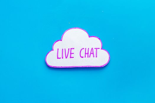 Live chat communication concept - words on blue background top view
