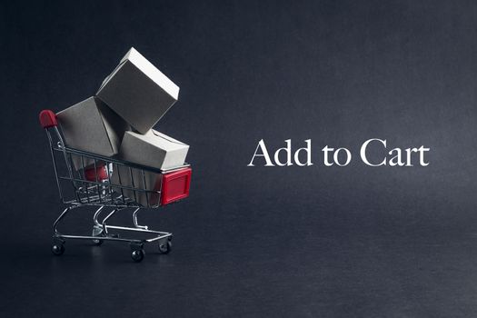 Shopping cart with words ADD TO CART on dark background