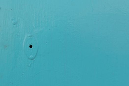 Minimalism style, Metal door blue color locked with padlock texture background.
