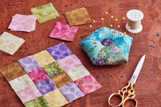 Quilting block from bright square pieces of fabrics, pin cushion