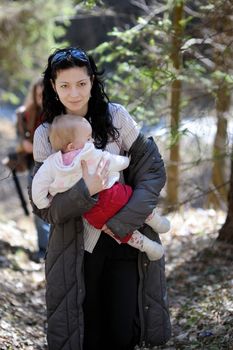 Young woman holding little baby girl