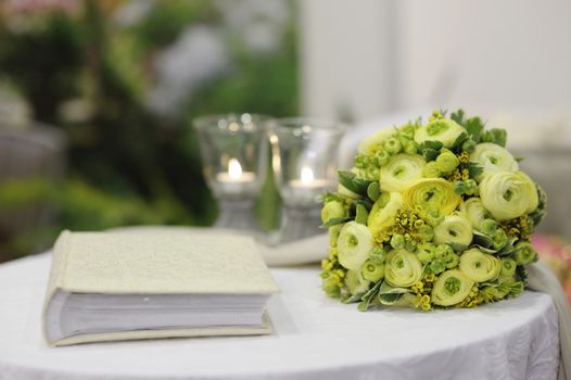 Beautiful flowers and a photo album on a table
