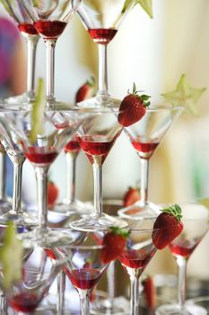 Deliciuos red coctail tower with strawberries