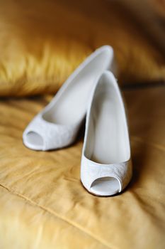 Bride's shoes on yellow carpet