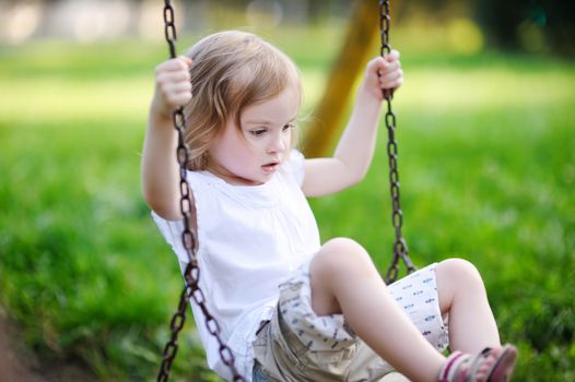 Little girl having fun on a swing