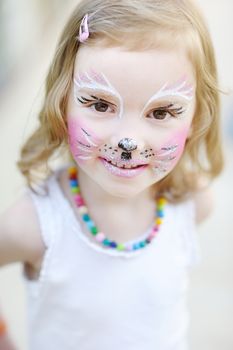 Adorable little girl with her face painted