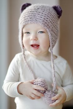 One year old toddler girl in funny hat