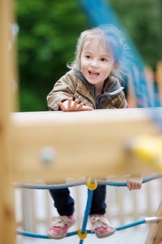 Adorable girl having fun on a playground