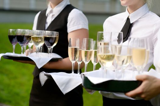 Waitress with dish of champagne glasses