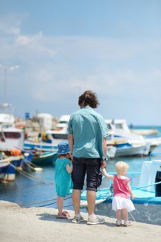 Young father and his kids at fisherman village