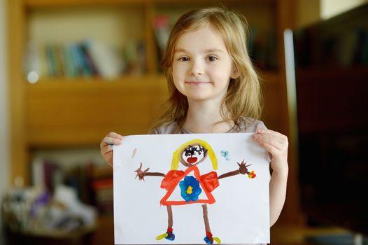 Little preschooler girl displaying her picture