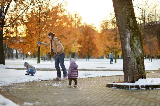 Father and two kids having fun on winter day