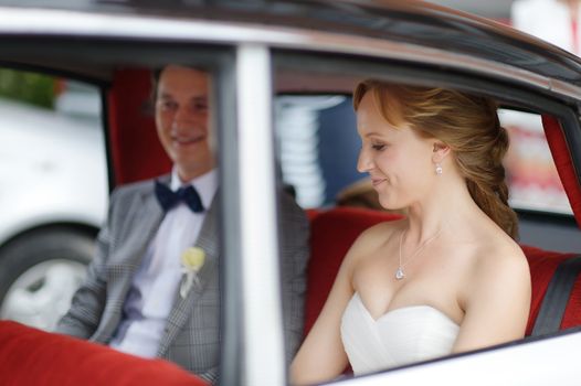 Bride and groom in a wedding car