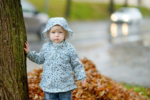 Adorable toddler girl at rainy day