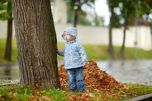 Adorable toddler girl at rainy day