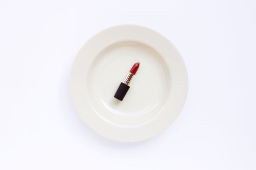 Lipstick on white dish  on white background. 