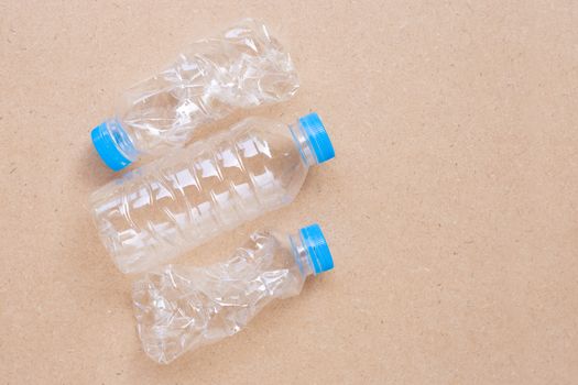 Plastic bottles on plywood background.