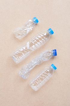 Plastic bottles on plywood background. 