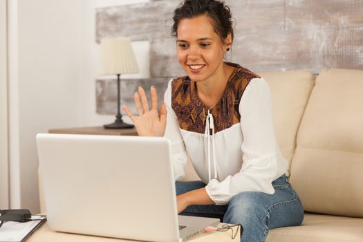 Freelancer waving in video call
