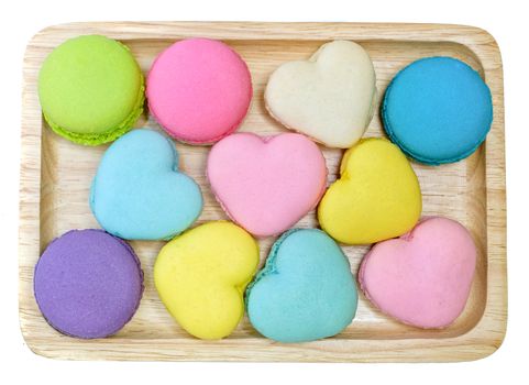 multi colored macaroons on a wooden trey