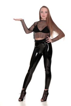 Young woman in black shiny leggings and net blouse holding imagi