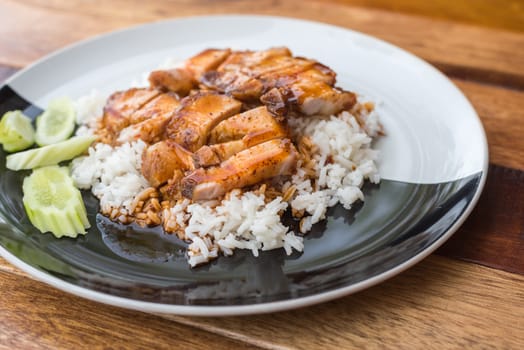 Barbecued red pork in sauce with rice and cucumber