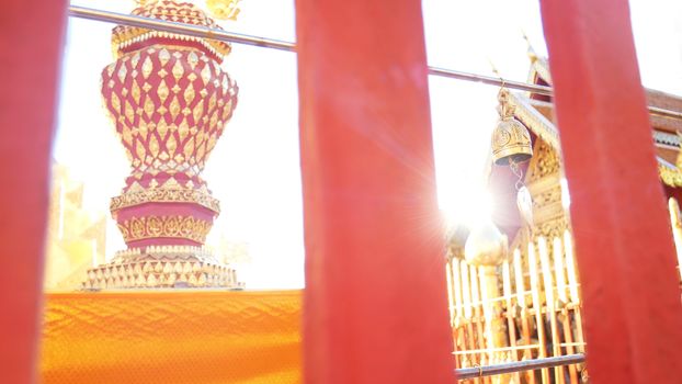 Golden Buddhist bell for prayer wishes in sunlight at Wat Phra That Doi Suthep temple, Chiang Mai, Thailand. Wat Phra That Doi Suthep is popular famous tourist temple attraction landmark in Chiangmai