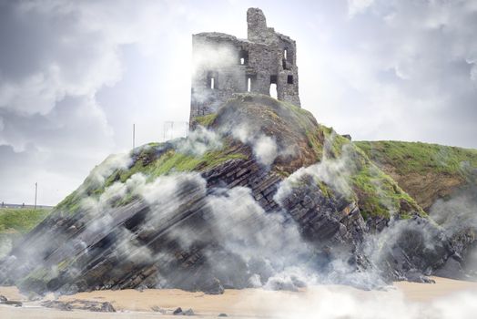Ballybunion castle ruins on cliff top in foggy mist