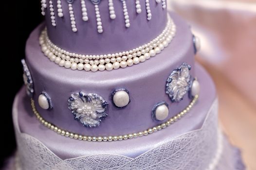 Purple wedding cake decorated with flowers