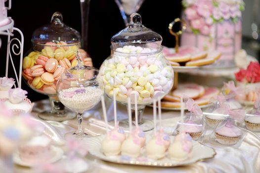 Decorated colorful candies on a white table