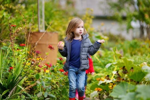 Cute little girl having fun in a garden