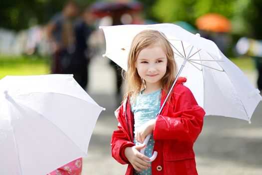 Adorable little girl at rainy day in autumn