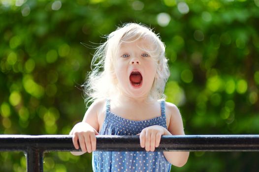 Adorable toddler girl making funny faces