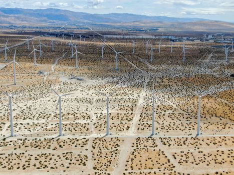 Aerial view of huge array of gigantic wind turbines spreading over the desert in Palm Springs.