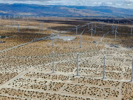 Aerial view of huge array of gigantic wind turbines spreading over the desert in Palm Springs.
