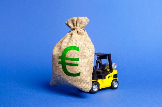 Yellow forklift truck carries a big bag of Euro money. Attracting investment in development, modernization of production and business. Revenue, profit, liquidity. profit fixation. capital migration
