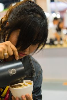 Barista pouring latte froth make coffee latte art