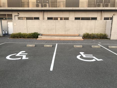 Handicapped Parking Spaces at Office Building. symbol car park. Handicapped parking spot - transportation infrastructure road markings