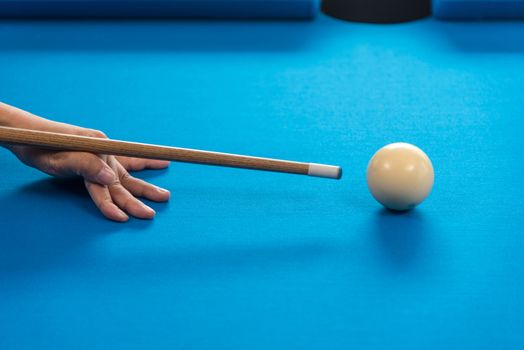 woman hand holding snooker stick playing pool or billiards