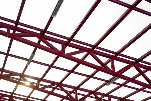 The glass roof is mounted on a metal frame which is painted red