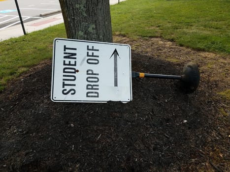 student drop off sign with arrow on the ground