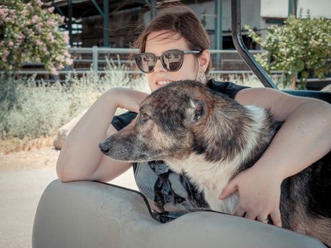 Caucasian woman is holding her dog while traveling
