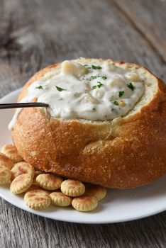 Vertical closeup of a bread bowl of New England Clam Chowder on 