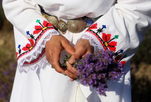 People in traditional costumes participate in the ancient ritual "Harvesting lavender"