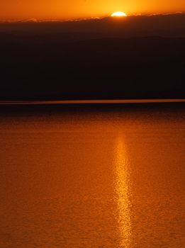 Sunset over the Dead Sea, view from the Jordanian shore to the Israeli mountains