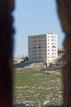 Skyscraper in the suburb of Karak in Jordan, taken from the loophole at the tower of the crusader castle