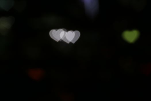 Valentines Colorful heart-shaped on black background lighting bokeh for decoration at night backdrop wallpaper blurred valentine, Love Pictures background, Lighting heart shaped soft at night abstract
