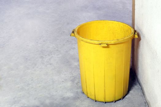 bin plastic yellow color old for waste dump, empty bin for garbage waste on floor, dirty bin plastic, trash bin for recycle waste