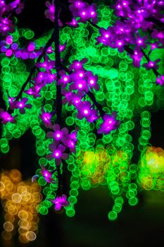 Sakura branch. Abstract background with bubble bokeh defocused lights. Majestic tree of lights. Fantastic forest.